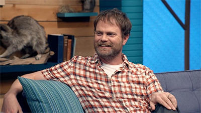 Rainn Wilson Wears a Short Sleeved Plaid Shirt & Colorful Sneakers Summary